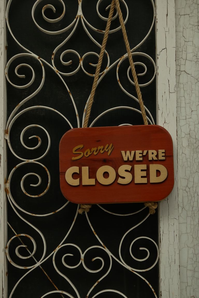 A stylish 'Sorry We're Closed' sign on an ornate door offers a vintage feel.